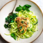 Keto Tuscan Garlic Chicken over zucchini noodles in bowl