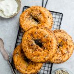 Top view of 4 low carb everything bagels on a wire rack
